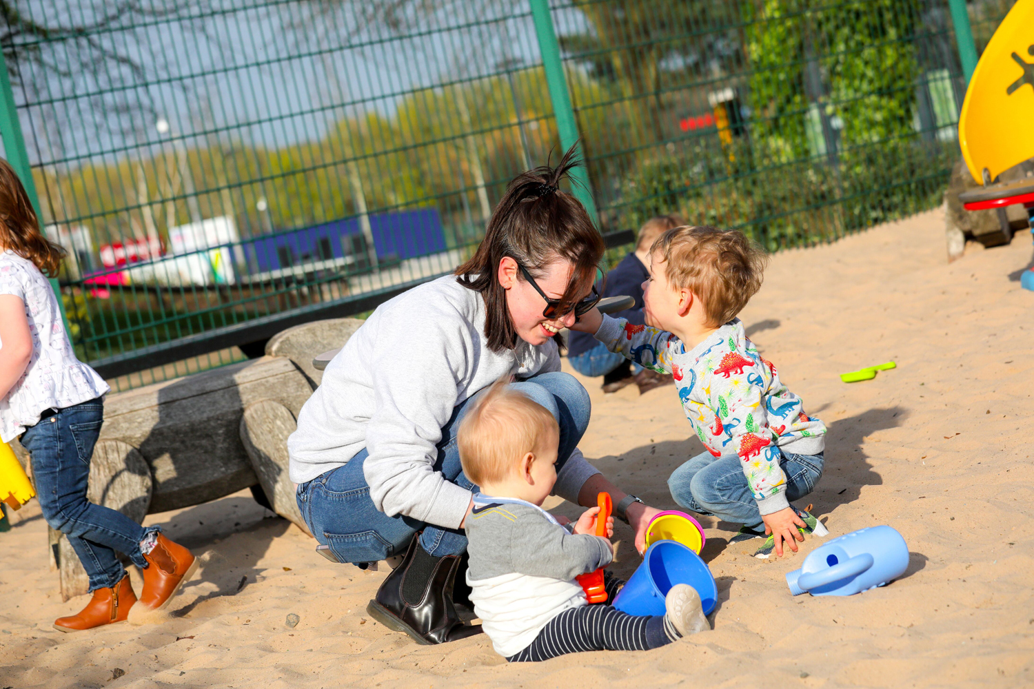 Illustration of a family playing in the sand pit at Telford Town Park